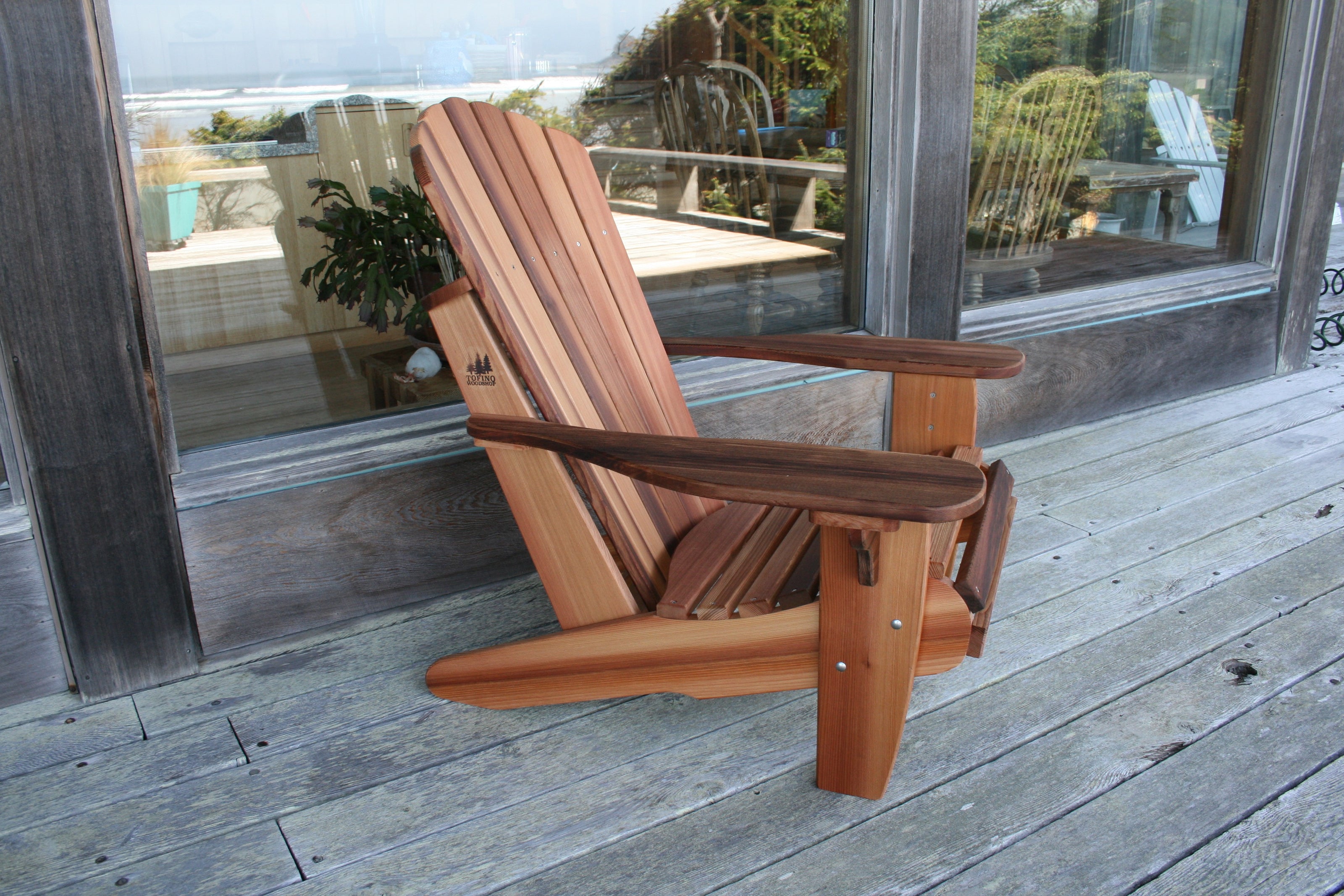 Side view of a cedar Adirondack or Muskoka chair showing its sloping seat and extended rear legs