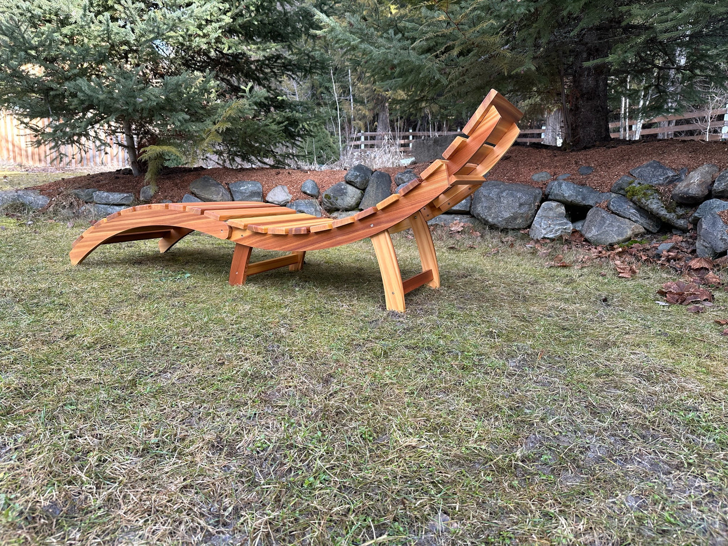 Rear angled view of the cedar lounger showing the curved frame and back