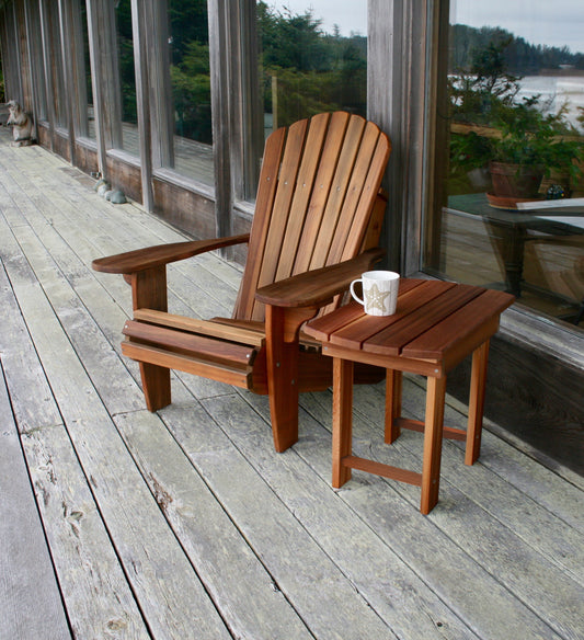 Western Red Cedar Adirondack chair with matching side table and mug on a weathered wood deck