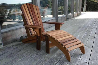 Western Red Cedar Adirondack chair with matching footrest on a wooden deck