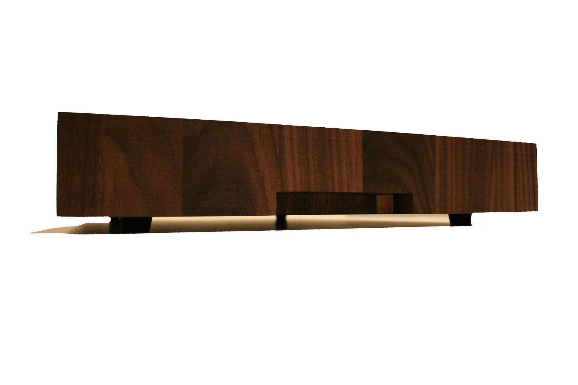 Side profile of the bordered end-grain cutting board showing its thick butcher block construction and rubber feet