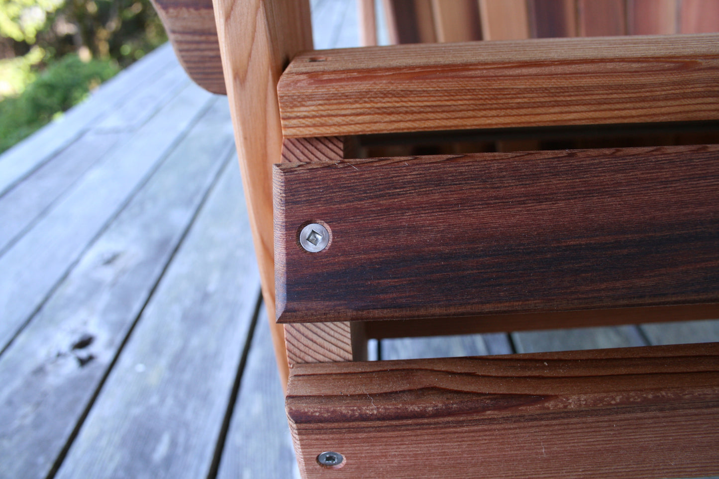 Close-up front the chair showing the seat slats, cedar joinery and stainless-steel fastener