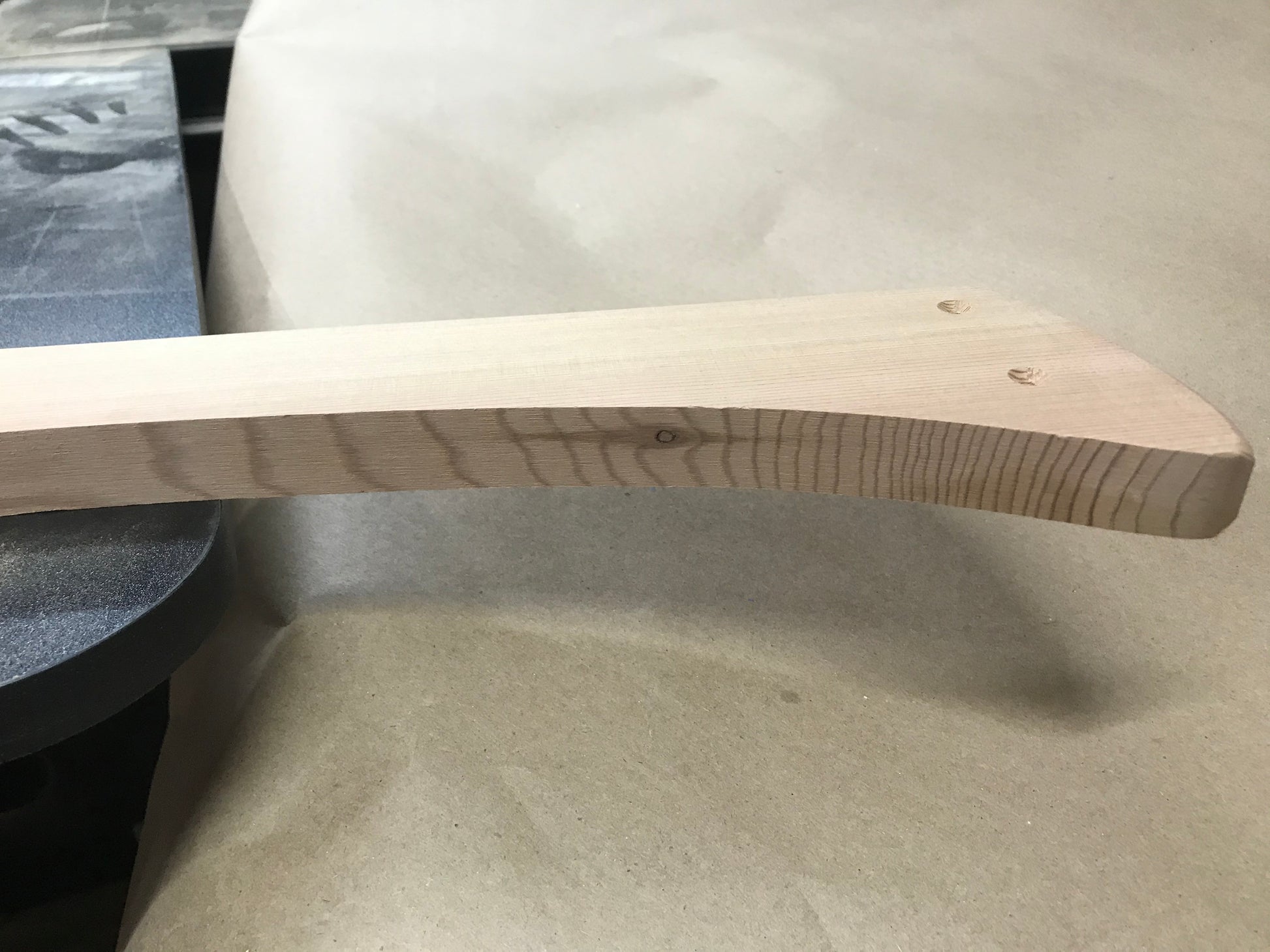 Example of a small knot revealed along the edge of a cedar Adirondack chair part