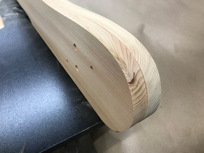 Example of a hidden knot exposed near the shaped end of a cedar Adirondack chair part
