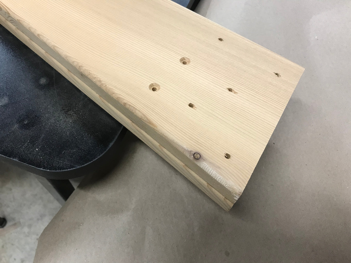 Example of small hidden knots revealed in a cedar Adirondack chair part during production