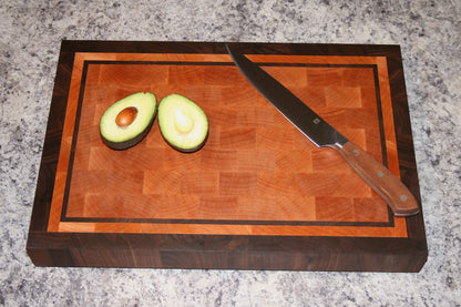 Bordered end-grain cutting board made from Eastern Maple and Black Walnut with avocado and knife