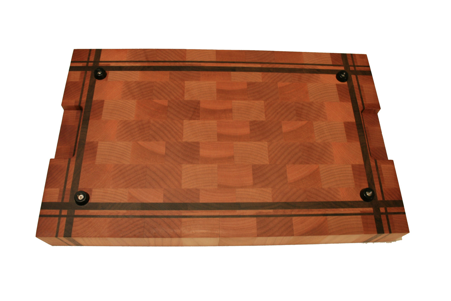 Underside of the end-grain cutting board showing four rubber feet and recessed handholds
