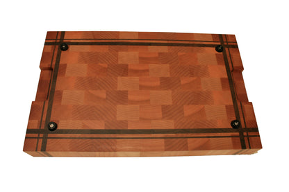 Underside of the end-grain cutting board showing four rubber feet and recessed handholds
