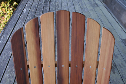 Close-up of the back slats showing straight vertical grain, stainless-steel fasteners and natural cedar tones