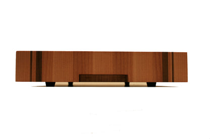 Side profile of the striped end-grain cutting board showing its thick butcher block construction