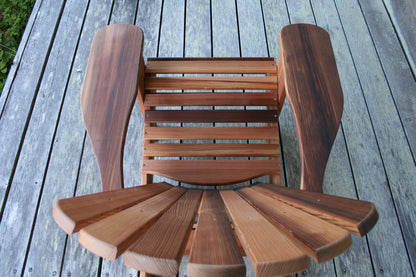 Top view showing the curved seat slats, broad arms and natural colour variation in the cedar